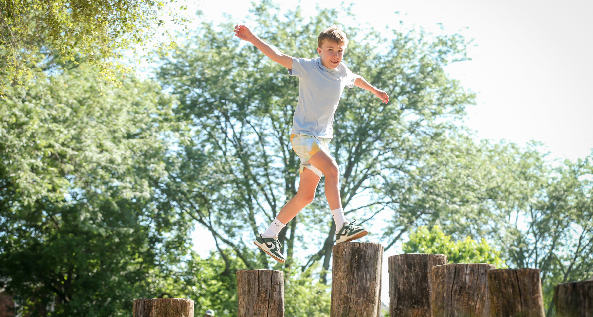 young boy jumping playing outside